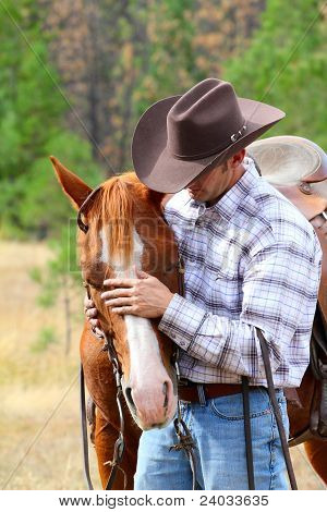 Picture or Photo of Cowboy working his horse in the field