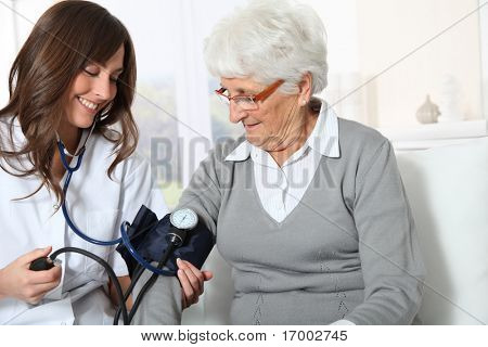 Picture or Photo of Closeup of nurse checking senior woman blood pressure