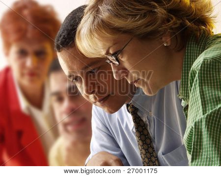 Picture or Photo of Business team working together in an office.