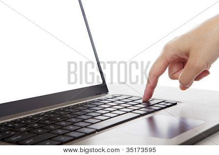 Picture or Photo of Closeup of a finger pressing enter button of ultrabook laptop computer