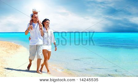 Picture or Photo of View of happy young family having fun on the beach