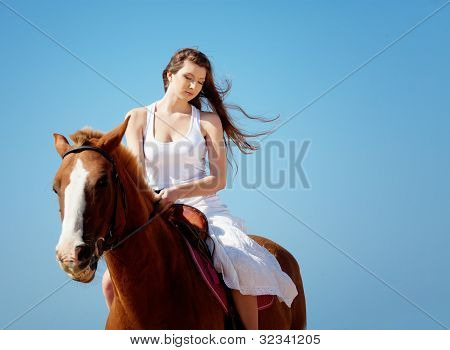 Picture or Photo of Girl in white dress with horse on the beach