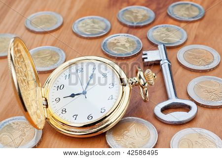Picture or Photo of Gold pocket watch on the background euro coins and keys.
