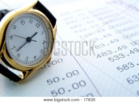 Picture or Photo of Watch resting on finance sheet
