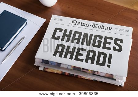 Picture or Photo of Newspaper with hot topic "Changes Ahead" lying on office desk.