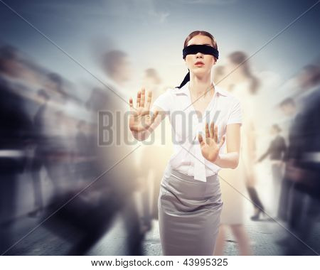 Picture or Photo of Image of businesswoman in blindfold walking among group of people
