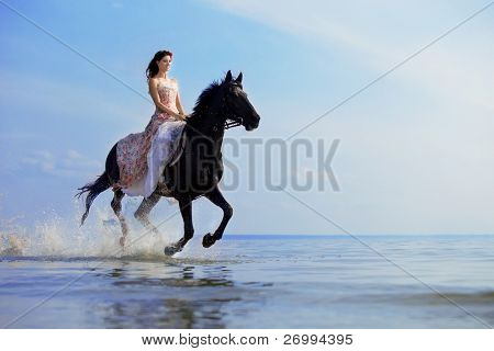 Picture or Photo of Image of a woman on a horse by the sea